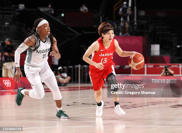 Rui Machida of Team Japan brings the ball up court against Ezinne Kalu of Team Nigeria during the second half of a Women's Basketball Preliminary...