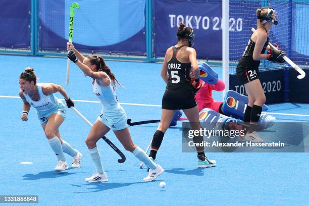 Eugenia Maria Trinchinetti of Team Argentina celebrates the the third goal scored while Selin Oruz and Pia Maertens of Team Germany look on during...