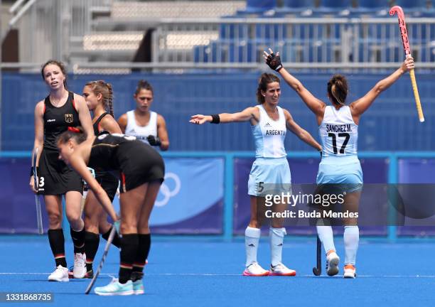 Agostina Alonso and Rocio Sanchez Moccia of Team Argentina react after their 3-0 win as players of Team Germany looks on after the Women's...