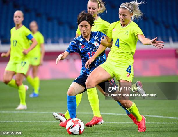 Mana Iwabuchi of Team Japan and Hanna Glas of Team Sweden compete for the ball during the Women's Quarter Final match between Sweden and Japan on day...