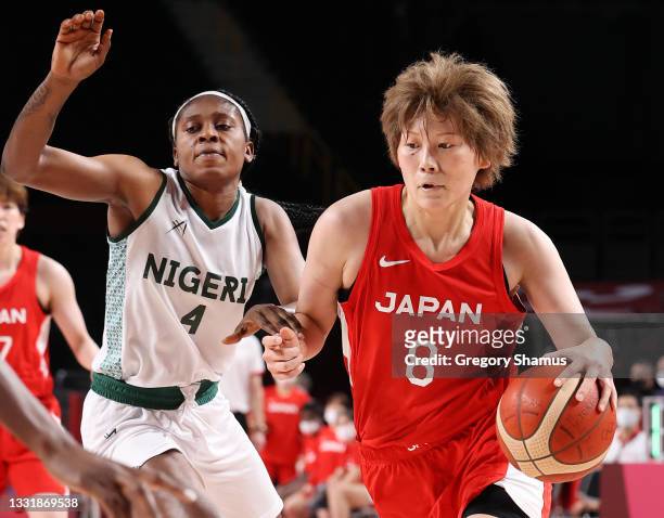 Maki Takada of Team Japan drives to the basket against Elizabeth Balogun of Team Nigeria during the second half of a Women's Basketball Preliminary...