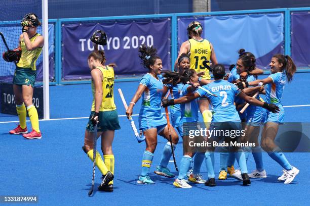 Gurjit Kaur of Team India celebrates scoring the first goal with teammates while Karri Somerville and Edwina Bone of Team Australia walk away during...