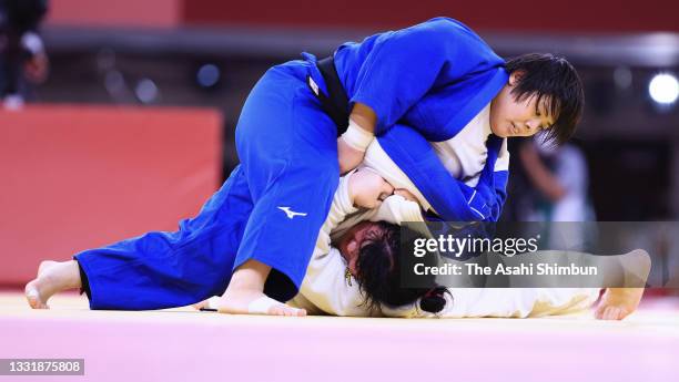 Akira Sone of Team Japan and Iryna Kindzerska of Azerbaijan compete in the Women's +78kg semi final on day seven of the Tokyo 2020 Olympic Games at...