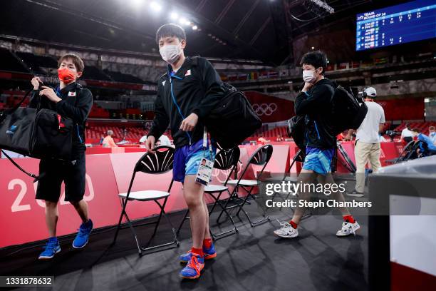 Koki Niwa, Tomokazu Harimoto and Jun Mizutani of Team Japan depart following their Men's Team Round of 16 table tennis match on day ten of the Tokyo...