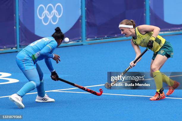 Emily Chalker of Team Australia passes the ball against Deep Grace Ekka of Team India during the Women's Quarterfinal match between Australia and...