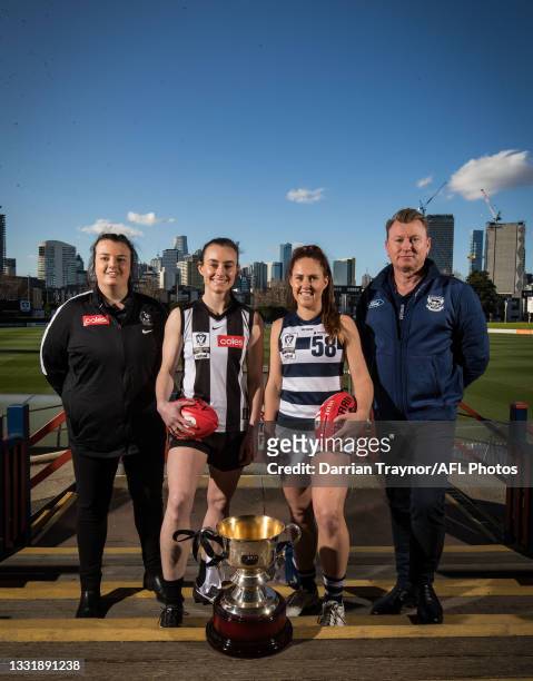 Collingwood VFLW Coach Chloe McMillan and captain Caitlin Bunker pose for a photo with Geelong VFLW captain Breanna Beckley and Coach Andrew Bruce...
