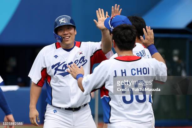 Hyunsoo Kim of Team South Korea celebrates with teammates after scoring in the seventh inning to end the game against Team Israel during the knockout...