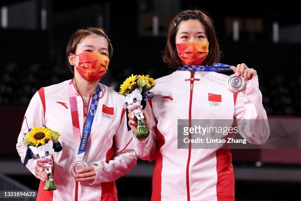Silver medalists Chen Qing Chen and Jia Yi Fan of Team China pose on the podium during the medal ceremony for the Women’s Doubles badminton event on...