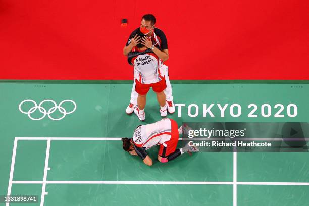 Greysia Polii and Apriyani Rahayu of Team Indonesia celebrate with their coach Eng Hian as they win against Chen Qing Chen and Jia Yi Fan of Team...