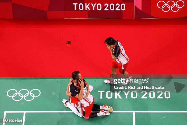 Greysia Polii and Apriyani Rahayu of Team Indonesia celebrate with their coach Eng Hian as they win against Chen Qing Chen and Jia Yi Fan of Team...