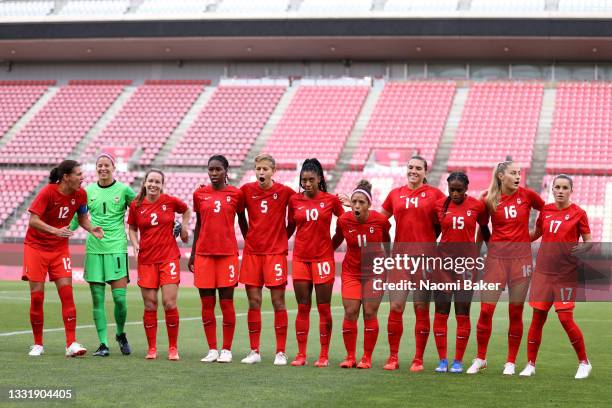 Players of Team Canada react during the national anthem prior to the Women's Semi-Final match between USA and Canada on day ten of the Tokyo Olympic...
