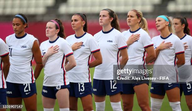 Lynn Williams, Rose Lavelle, Alex Morgan and Tierna Davidson, Lindsey Horan and Julie Ertz of Team United States stand for the national anthem prior...