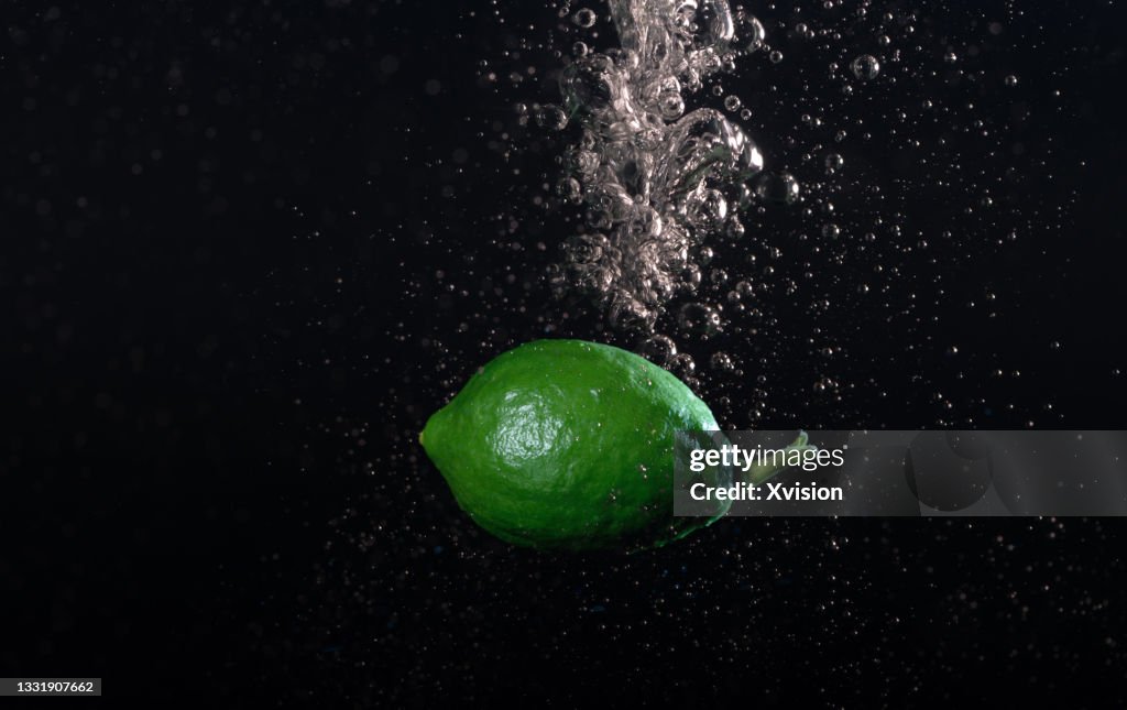 Lemon fell into water captured with high speed sync."n