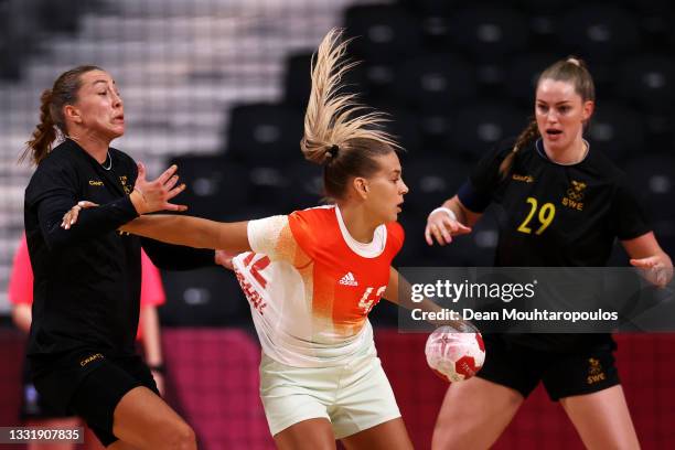 Katrin Gitta Klujber of Team Hungary is under pressure from Anna Lagerquist of Team Sweden as Kristin Thorleifsdottir of Team Sweden looks on during...