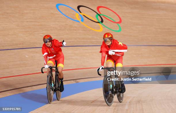 Tianshi Zhong and Shanju Bao of Team China celebrate winning the gold medal during the Women's team sprint finals, gold medal of the Track Cycling on...