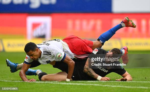 Robert Glatzel of Hamburg is challenged by Michael Sollbauer of Dresden during the Second Bundesliga match between Hamburger SV and SG Dynamo Dresden...