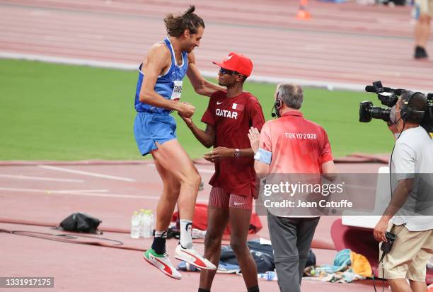 Gianmarco Tamberi of Italy and Mutaz Essa Barshim of Qatar share the Gold Medal in the Men's High Jump Final on day nine of the athletics events of...
