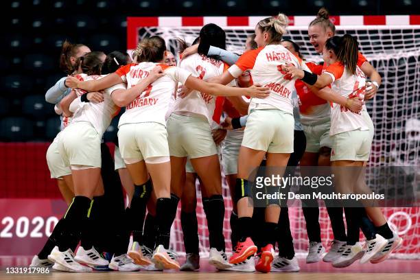 Team Hungary celebrate winning after the final whistle during the Women's Preliminary Round Group B handball match between Hungary and Sweden on day...
