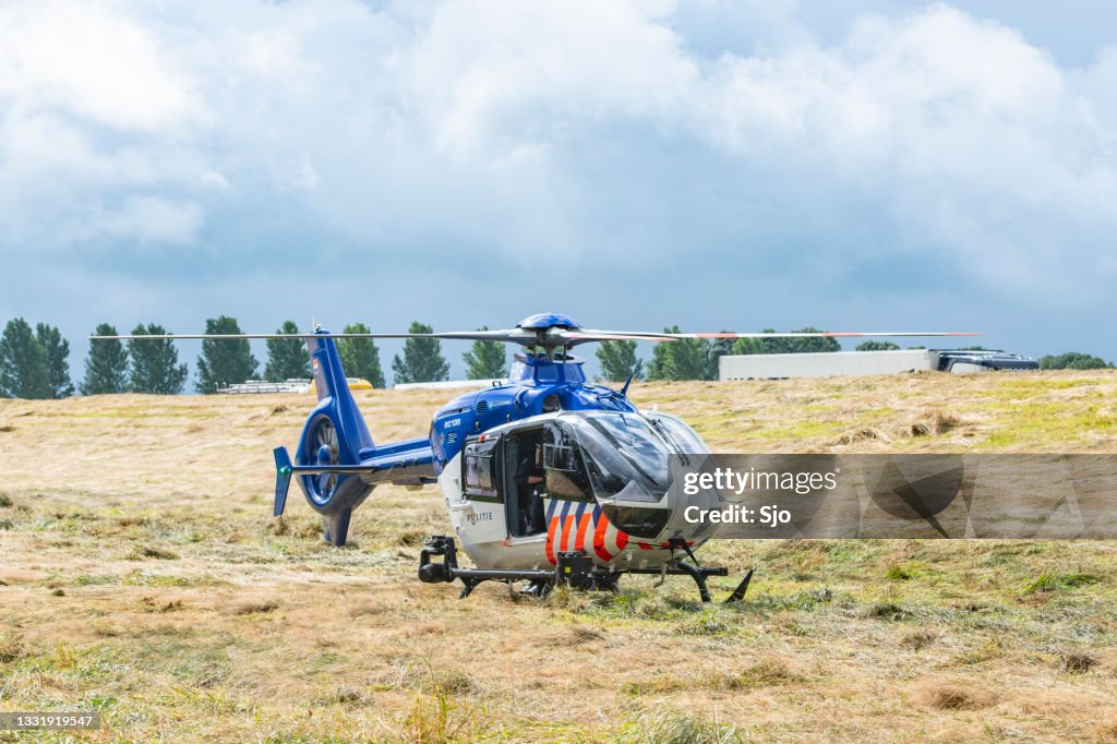 Helicopter of the Dutch Police Aviation Service landed in a field