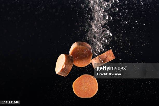 sweet potato flying in mid air captured with high speed sync."n - kartoffelblüte nahaufnahme stock-fotos und bilder