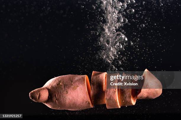 sweet potato flying in mid air captured with high speed sync."n - kartoffelblüte nahaufnahme stock-fotos und bilder