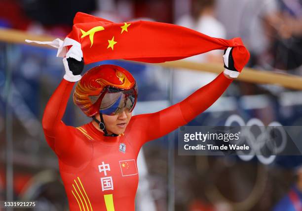 Tianshi Zhong of Team China celebrates winning the gold medal while holding the flag of they country after the Women's team sprint finals of the...