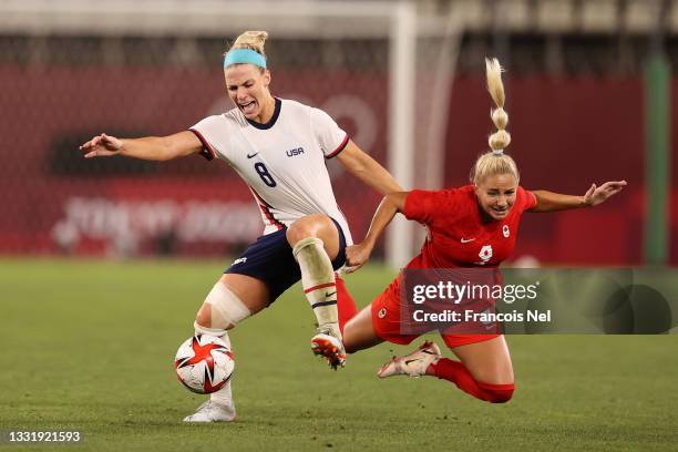 Adriana Leon of Team Canada is challenged by Julie Ertz of Team United States during the Women's Semi-Final match between USA and Canada on day ten...