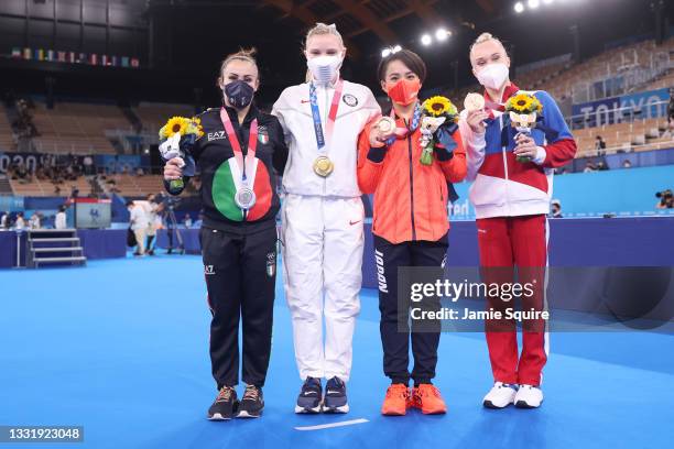 From left - Vanessa Ferrari of Team Italy, Jade Carey of Team United States, Mai Murakami of Team Japan and Angelina Melnikova of Team ROC display...