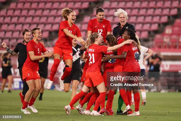 Quinn, Shelina Zadorsky, Christine Sinclair of Team Canada and team mates celebrate their side's victory after the Women's Semi-Final match between...