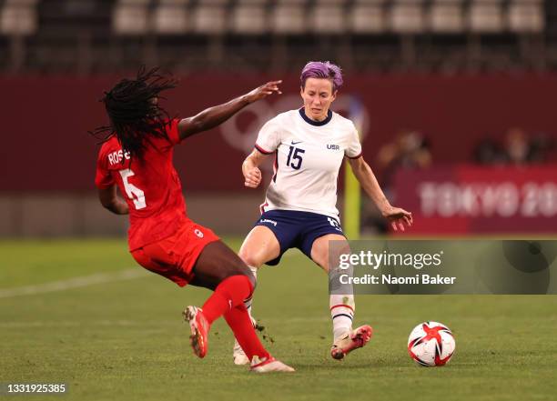 Quinn of Team Canada is challenged by Megan Rapinoe of Team United States during the Women's Semi-Final match between USA and Canada on day ten of...