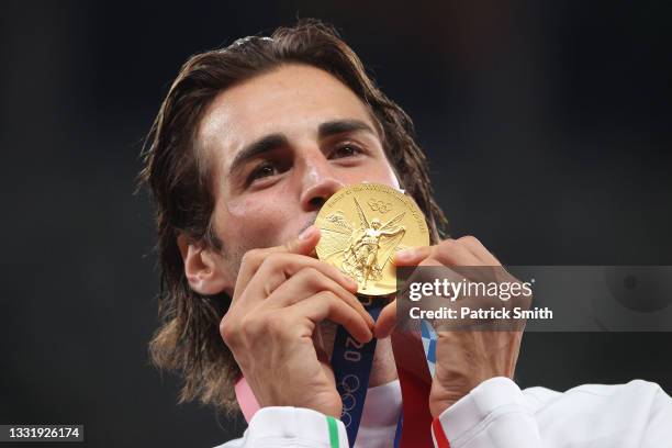 Joint gold medalist Gianmarco Tamberi of Team Italy kisses his medal on the podium during the medal ceremony for the Men's High Jump on day ten of...