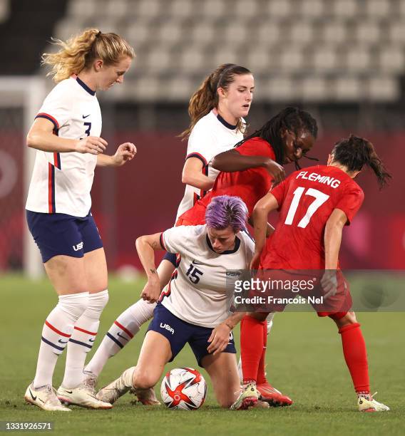 Megan Rapinoe of Team United States is challenged by Jessie Fleming of Team Canada during the Women's Semi-Final match between USA and Canada on day...