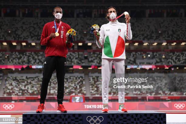 Joint gold medalists Mutaz Essa Barshim of Team Qatar and Gianmarco Tamberi of Team Italy celebrate on the podium during the medal ceremony for the...
