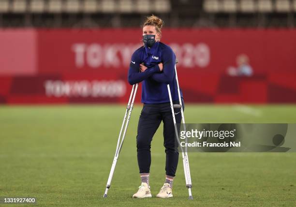 Alyssa Naeher of Team United States stands with crutches following her injury as she looks dejected following defeat in the Women's Semi-Final match...