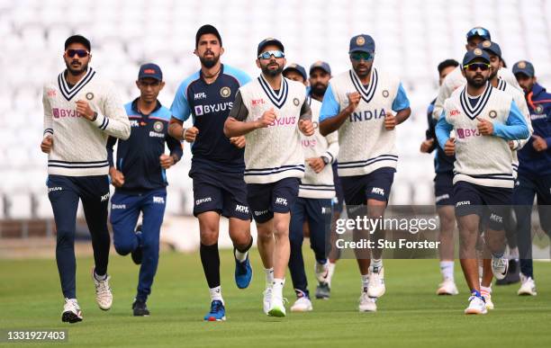 India captain Virat Kohli and team mates in running action during the warm up ahead of India nets ahead of the First Test Match between England and...