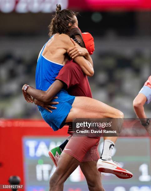 Gianmarco Tamberi of Team Italy and Mutaz Essa Barshim of Team Qatar react after winning the gold medal in the men's High Jump on day nine of the...