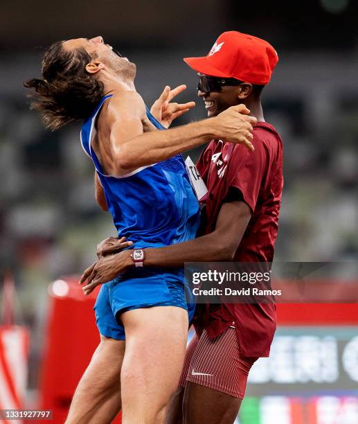 Gianmarco Tamberi of Team Italy and Mutaz Essa Barshim of Team Qatar react after winning the gold medal in the men's High Jump on day nine of the...