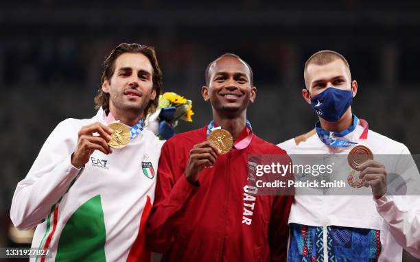 Joint gold medalists Gianmarco Tamberi of Team Italy and Mutaz Essa Barshim of Team Qatar and bronze medalist Maksim Nedasekau of Team Belarus...