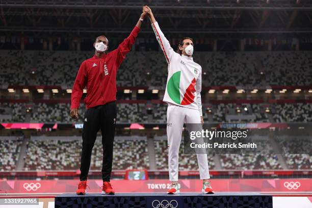 Joint gold medalists Mutaz Essa Barshim of Team Qatar and Gianmarco Tamberi of Team Italy celebrate on the podium during the medal ceremony for the...