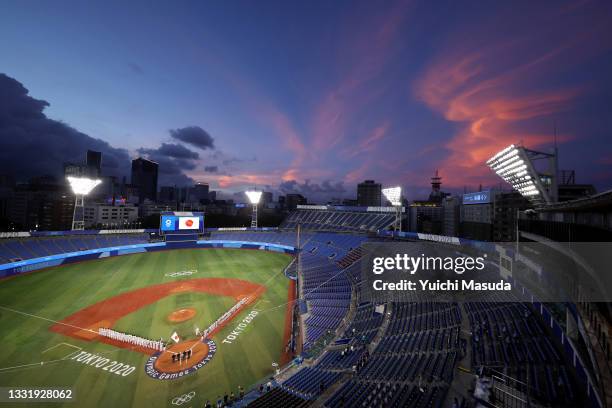 The sun sets as Team Japan and Team United States line up for national anthems prior to the knockout stage of men's baseball on day ten of the Tokyo...