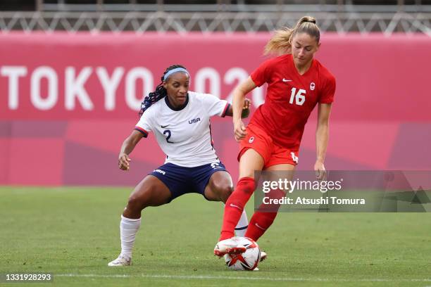 Janine Beckie of Team Canada battles for possession with Crystal Dunn of Team United States during the Women's Semi-Final match between USA and...