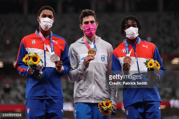 Silver medalist Juan Miguel Echevarria of Team Cuba, gold medalist Miltiadis Tentoglou of Team Greece and bronze medalist Maykel Masso of Team Cuba...