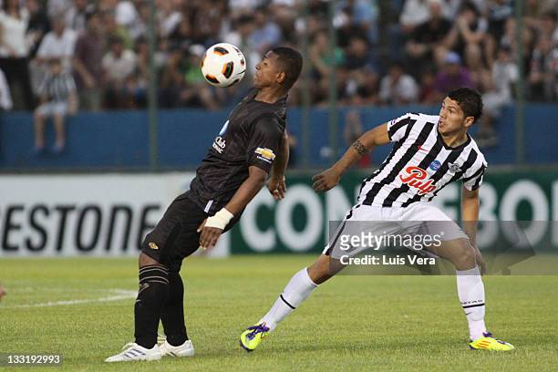 Jorge Guagua, from Liga Universitaria de Quito, fights for the ball with Robin Ramirez, from Libertad, during a match between Liga Universitaria de...
