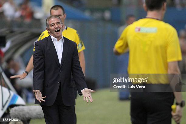 Coach Jorge Burruchaga, from Libertad of Paraguay, gestures to line referee during a match between Liga Universitaria de Quito of Ecuador and...