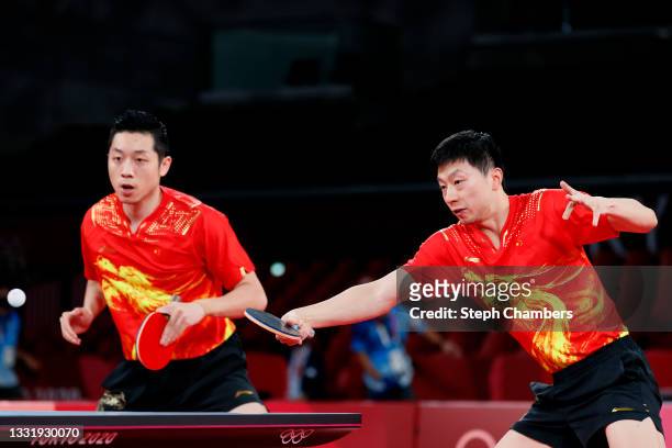 Ma Long and Xu Xin of Team China in action during their Men's Team Quarterfinals table tennis match on day ten of the Tokyo 2020 Olympic Games at...