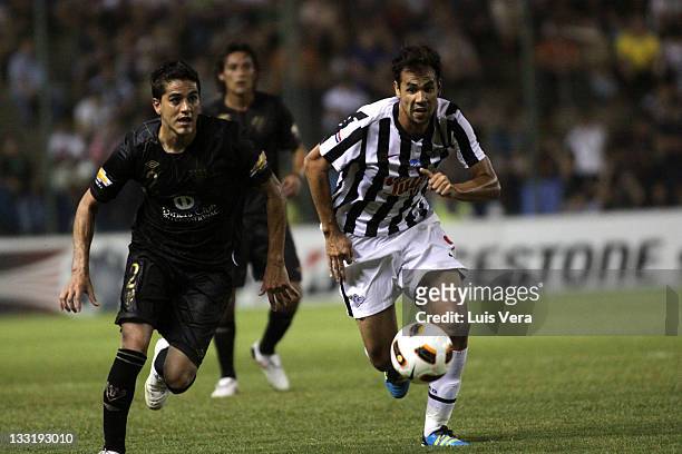 Pablo Velazquez from Libertad, fights for the ball with Norberto Araujo , from Liga Universitaria de Quito, during a match between Liga Universitaria...