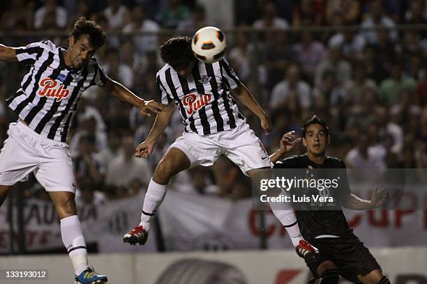 Pablo Velazquez and Gustavo Mencia , from Libertad, fights for the ball with Norberto Araujo , from Liga Universitaria de Quito, during a match...