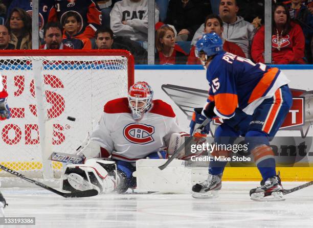 Goaltender Peter Budaj of the Montreal Canadiens watches the puck shoot past him into the net for a second-period goal by P.A. Parenteau of the New...