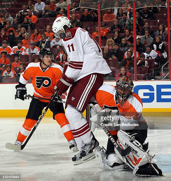 Martin Hanzal of the Phoenix Coyotes is struck by the airborn puck in an attempt to screen goaltender Ilya Bryzgalov of the Philadelphia Flyers on...