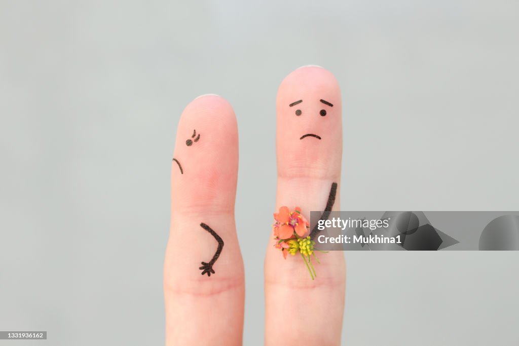 Fingers art of couple. Man gives a woman a bouquet of flowers, she is not satisfied.